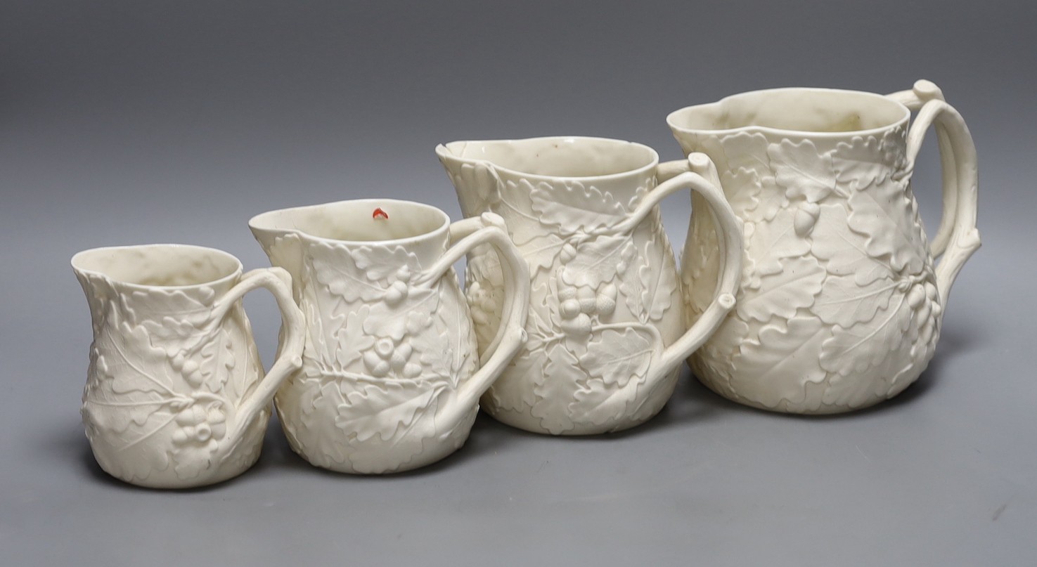 A graduated set of four Victorian parian oak leaf jugs, tallest 15.5cm